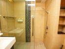 Modern bathroom interior with walk-in shower and beige tiles