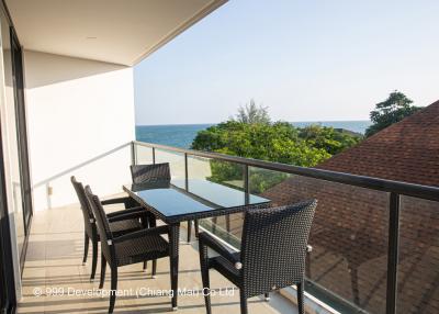 Spacious balcony with sea view and outdoor dining set
