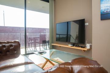 Modern living room with large windows and leather sofa