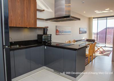 Modern kitchen with black countertops and wooden cabinetry