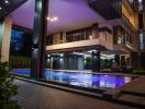 Luxurious outdoor pool area with ambient lighting in the evening