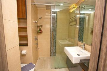 Modern bathroom with glass shower and elegant tiling