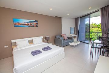 Spacious and modern bedroom with attached sitting area and balcony