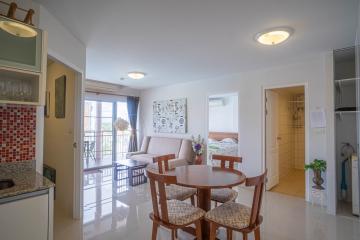 Bright and cozy living room with dining area and open kitchen