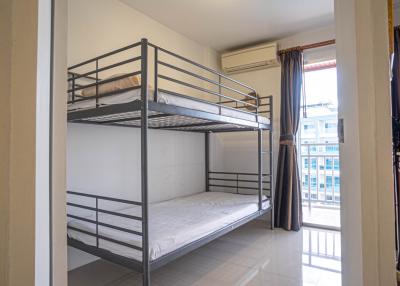 Compact bedroom with bunk bed and balcony access