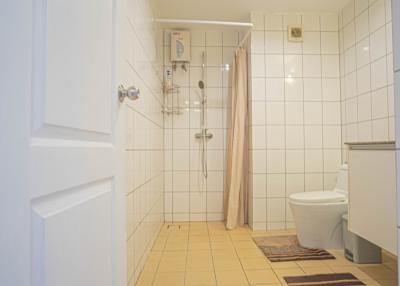 Bright clean bathroom with shower and toilet