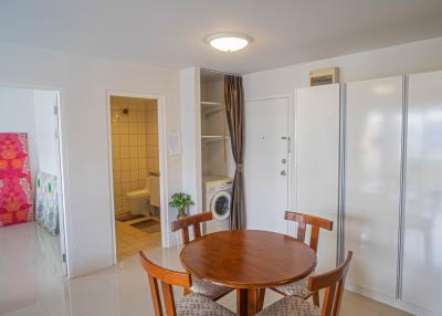 Brightly lit interior with dining area, adjoining bathroom, and laundry facilities