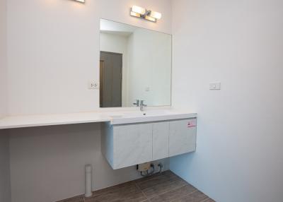 Modern bathroom with large mirror and floating vanity