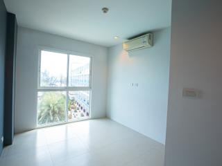 Spacious bedroom with large window and air conditioning unit