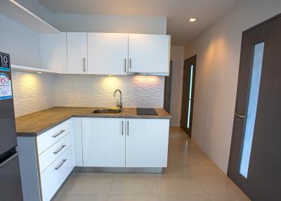 Modern kitchen with white cabinets and stainless steel appliances