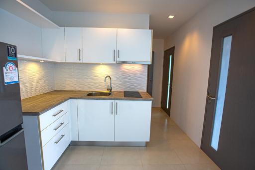 Modern kitchen with white cabinets and stainless steel appliances