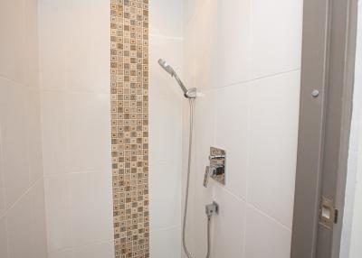 Modern white tiled bathroom with a shower