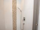 Modern white tiled bathroom with a shower