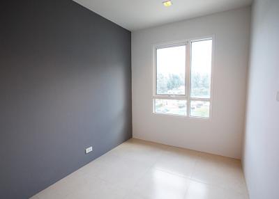 Empty bedroom with large window and gray accent wall