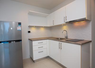 Modern white-themed kitchen with stainless steel appliances