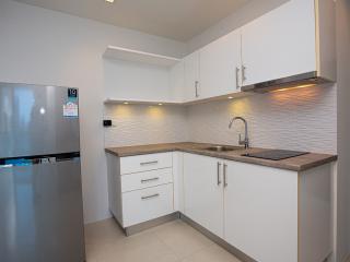 Modern white-themed kitchen with stainless steel appliances