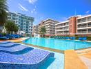 Luxurious pool area with loungers in a modern residential complex