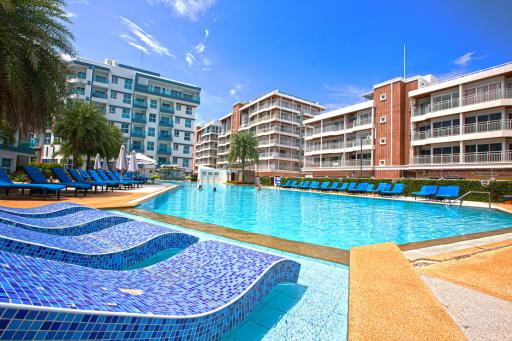 Luxurious pool area with loungers in a modern residential complex