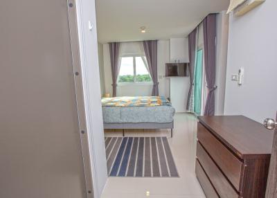 Spacious bedroom with natural lighting and en suite bathroom