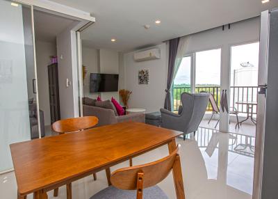Spacious living room with dining area and balcony access