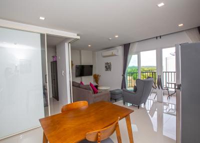 Spacious living room with modern furnishings and balcony access