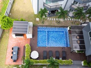Aerial view of a residential backyard with swimming pool and patio