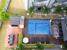 Aerial view of a residential backyard with swimming pool and patio
