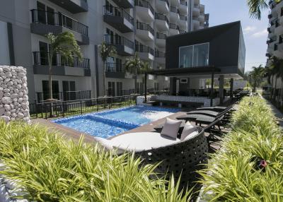 Modern apartment complex with outdoor pool and lounge area