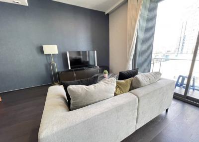 Modern living room with dark accent wall and large windows