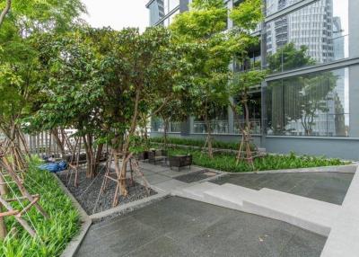 Modern common area with lush greenery outside a residential building