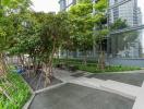 Modern common area with lush greenery outside a residential building