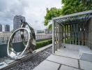 Modern rooftop garden with artistic sculptures and city view