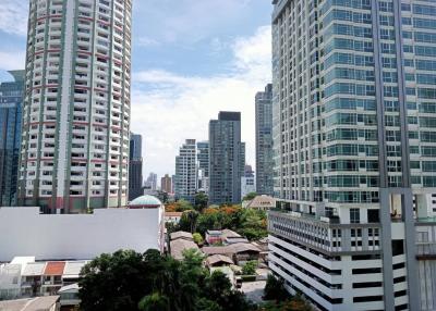 Urban skyline with multiple high-rise buildings and clear blue sky