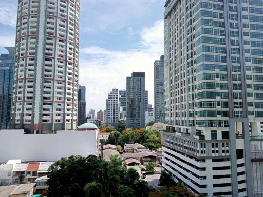 Urban skyline with multiple high-rise buildings and clear blue sky