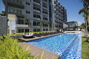 Modern residential building with an outdoor swimming pool and lounge areas