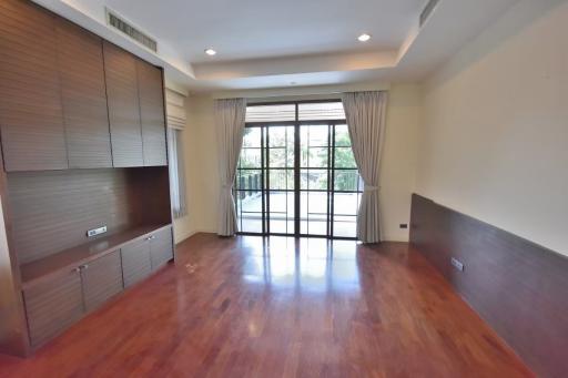 Spacious living room with natural light and hardwood floors