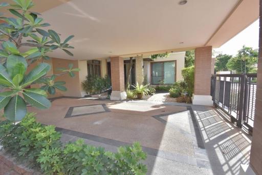 Spacious front patio entrance of a modern suburban home with garden