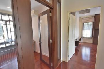 Spacious hallway in a modern apartment with wooden floors and natural light