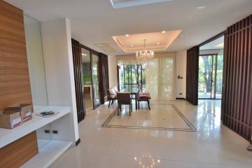 Spacious and well-lit living room with modern decor and large windows