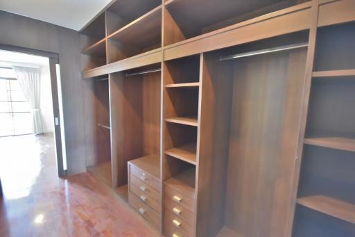 Spacious bedroom walk-in closet with custom shelving and storage solutions