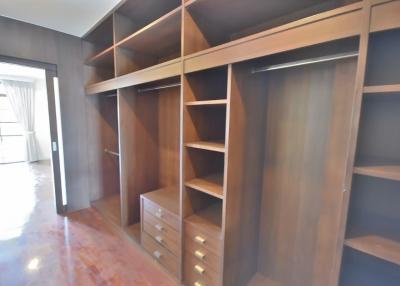 Spacious bedroom walk-in closet with custom shelving and storage solutions