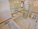 Spacious modern bathroom with dual sinks and glass shower enclosure