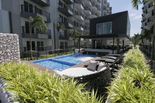 Luxurious apartment complex with a pool and lounge area