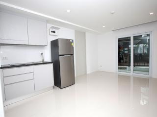 Spacious and modern kitchen interior with stainless steel refrigerator