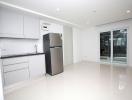 Spacious and modern kitchen interior with stainless steel refrigerator