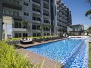Modern apartment complex with swimming pool and luxurious amenities