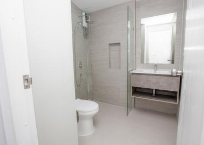 Modern white bathroom with shower and glass door