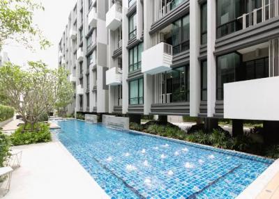 Modern residential building with pool and landscaped area