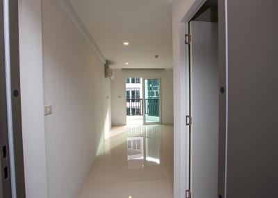 Spacious and well-lit hallway leading to a balcony in a modern apartment