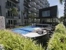 Modern residential complex with pool and lounge area